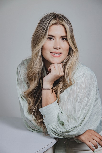 professional headshot woman with red hair in tailored blazer, confident professional styling, natural outdoor light