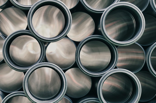 tailored wide leg trousers in cream linen on model walking through sunlit garden, elegant flowing movement, professional fashion photography with natural depth